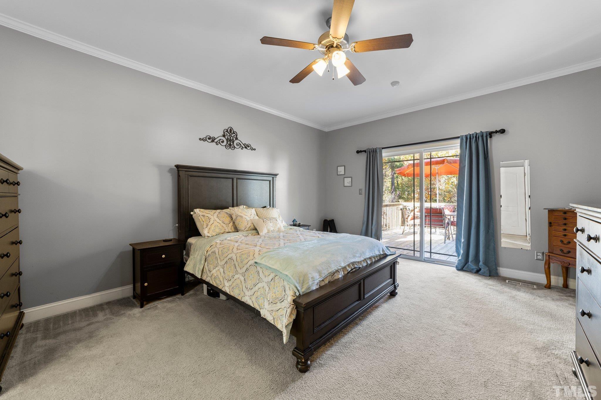 270 Timberland Drive Angier, NC 27501 - Photo 13 of 30 a spacious bedroom with a bed and a chandelier