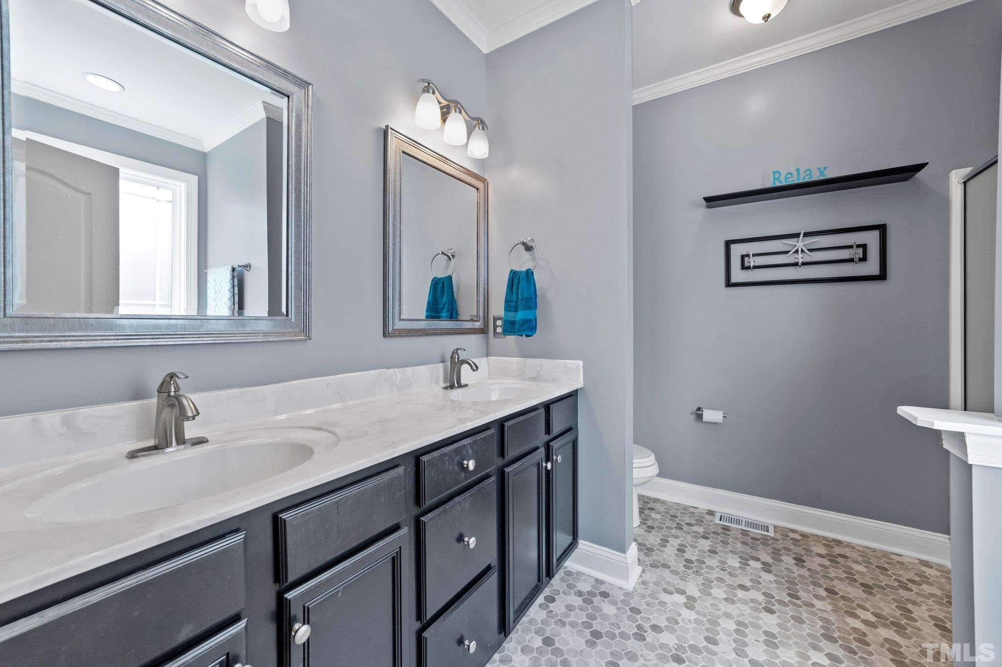 270 Timberland Drive Angier, NC 27501 - Photo 14 of 30 a bathroom with a double vanity sink and a mirror