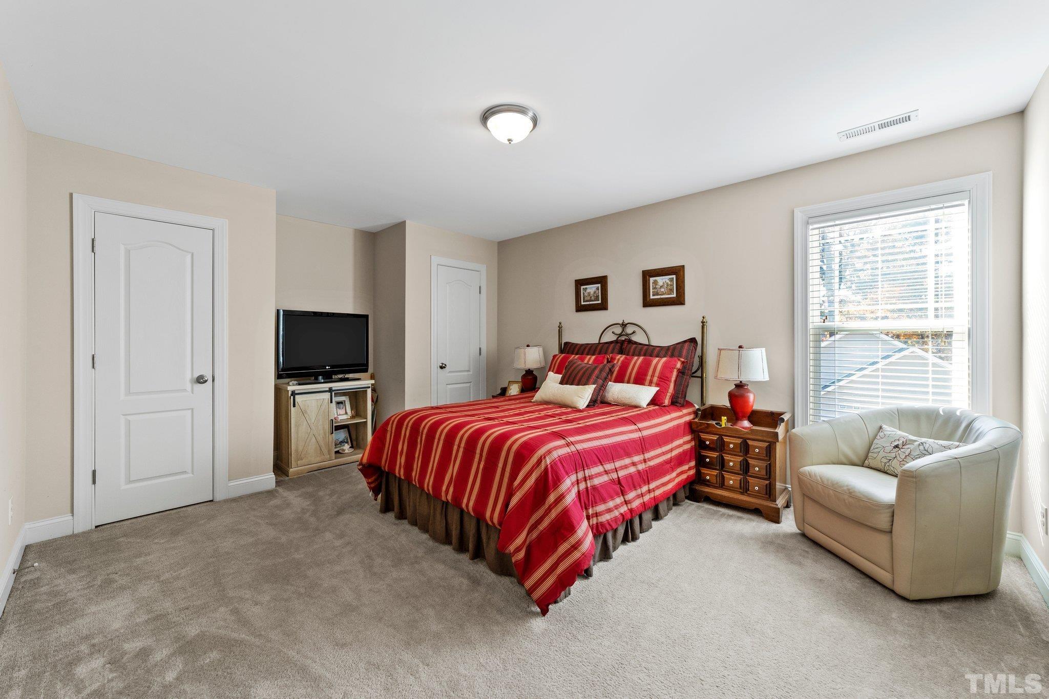 270 Timberland Drive Angier, NC 27501 - Photo 17 of 30 a bedroom with a bed and a flat screen tv