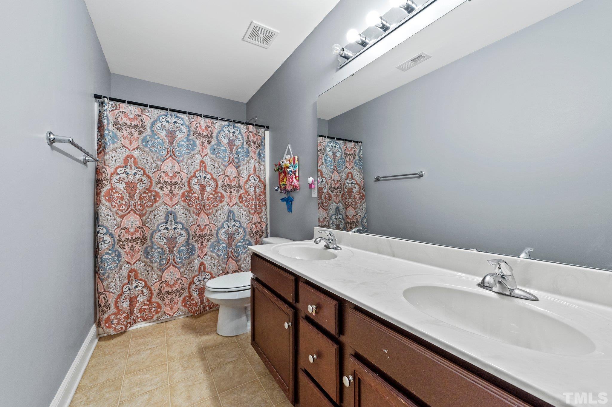 270 Timberland Drive Angier, NC 27501 - Photo 18 of 30 a bathroom with a sink double vanity and a toilet