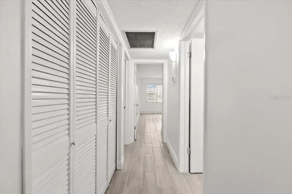 a view of a hallway with wooden floor