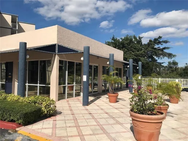 a view of a house with backyard porch and sitting area