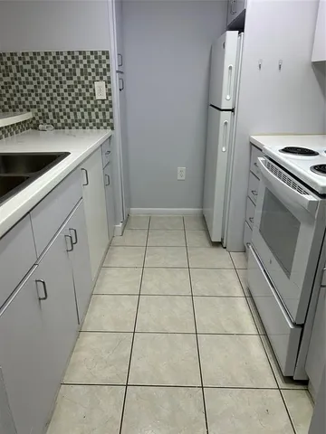 a kitchen with a sink and a stove