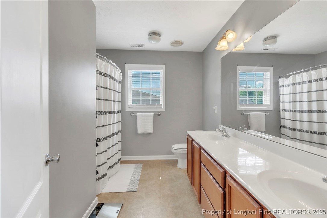 665 Cape Fear Road Raeford, NC 28376 - Photo 19 of 33 a bathroom with a sink a vanity and a bathtub
