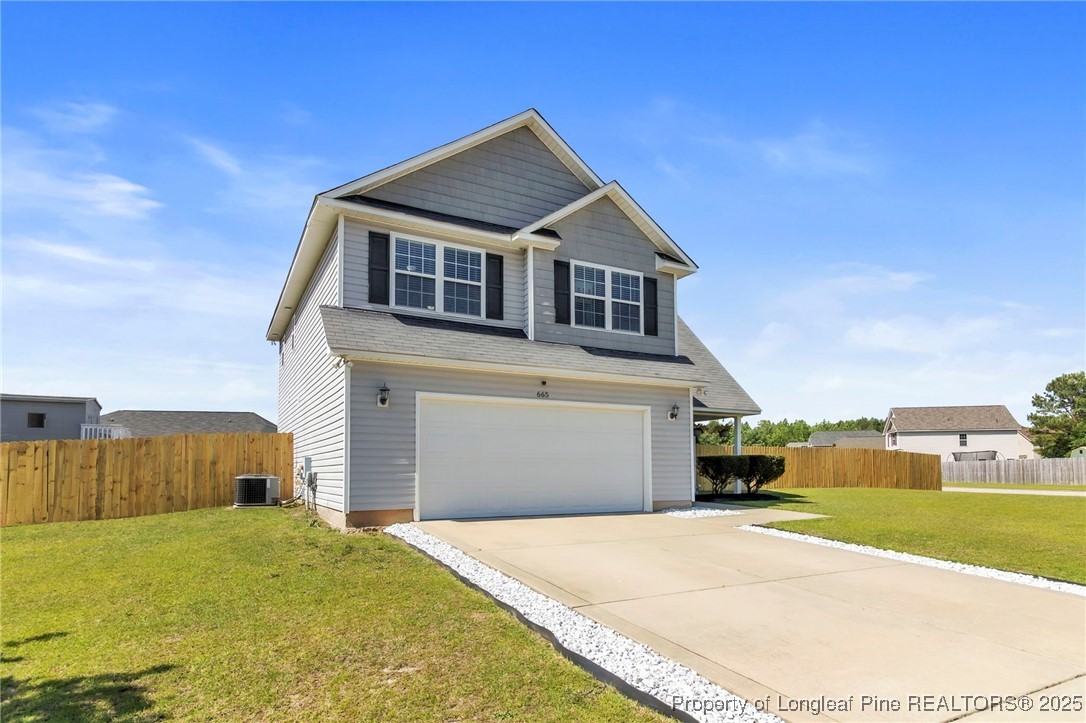 665 Cape Fear Road Raeford, NC 28376 - Photo 3 of 33 a front view of a house with a yard