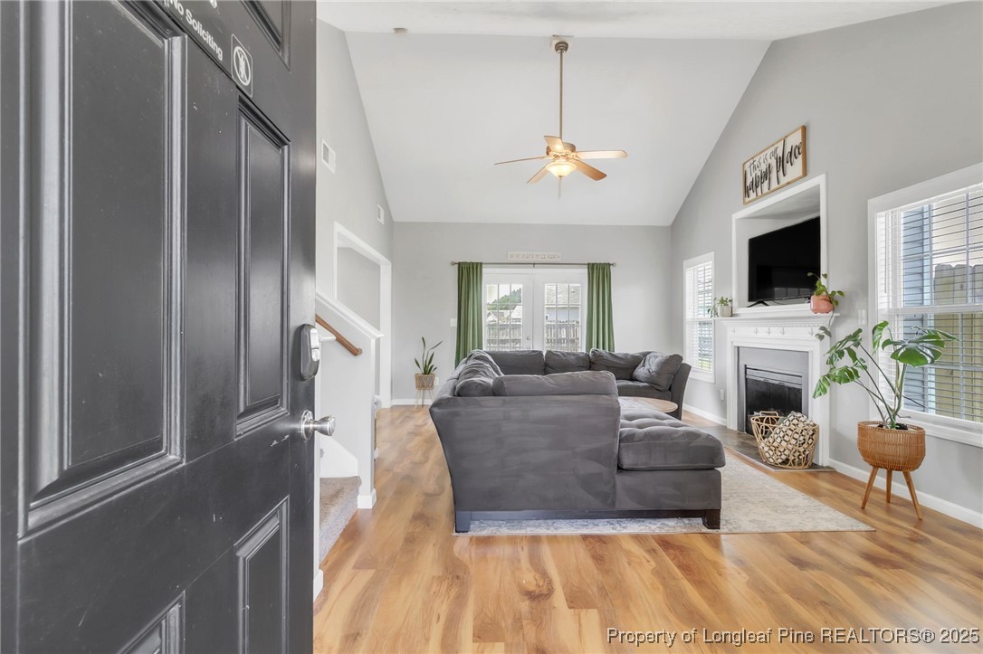 665 Cape Fear Road Raeford, NC 28376 - Photo 5 of 33 a living room with furniture a fireplace and a flat screen tv