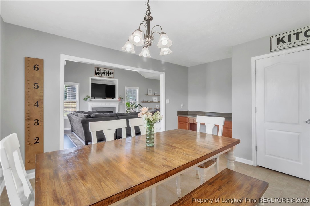 665 Cape Fear Road Raeford, NC 28376 - Photo 10 of 33 a dining room with wooden floor and chandelier