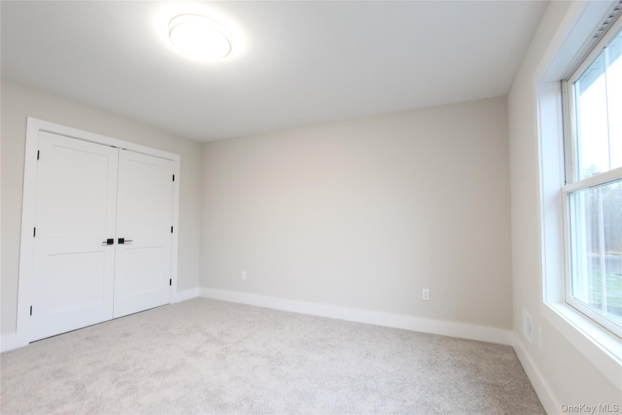 5 Colonels Path Manorville, NY 11949 - Photo 11 of 19 Unfurnished bedroom with carpet floors and a closet