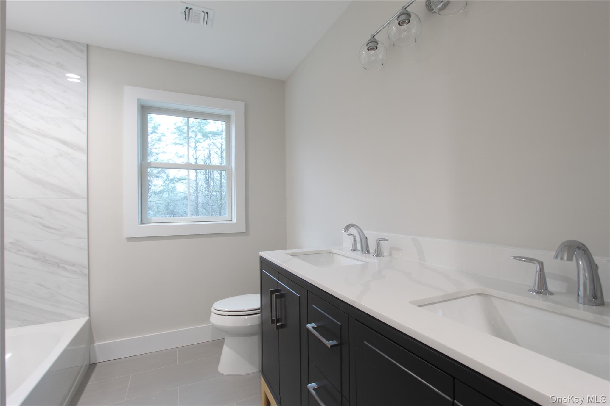 5 Colonels Path Manorville, NY 11949 - Photo 12 of 30 Bathroom featuring double vanity and tile patterned floors