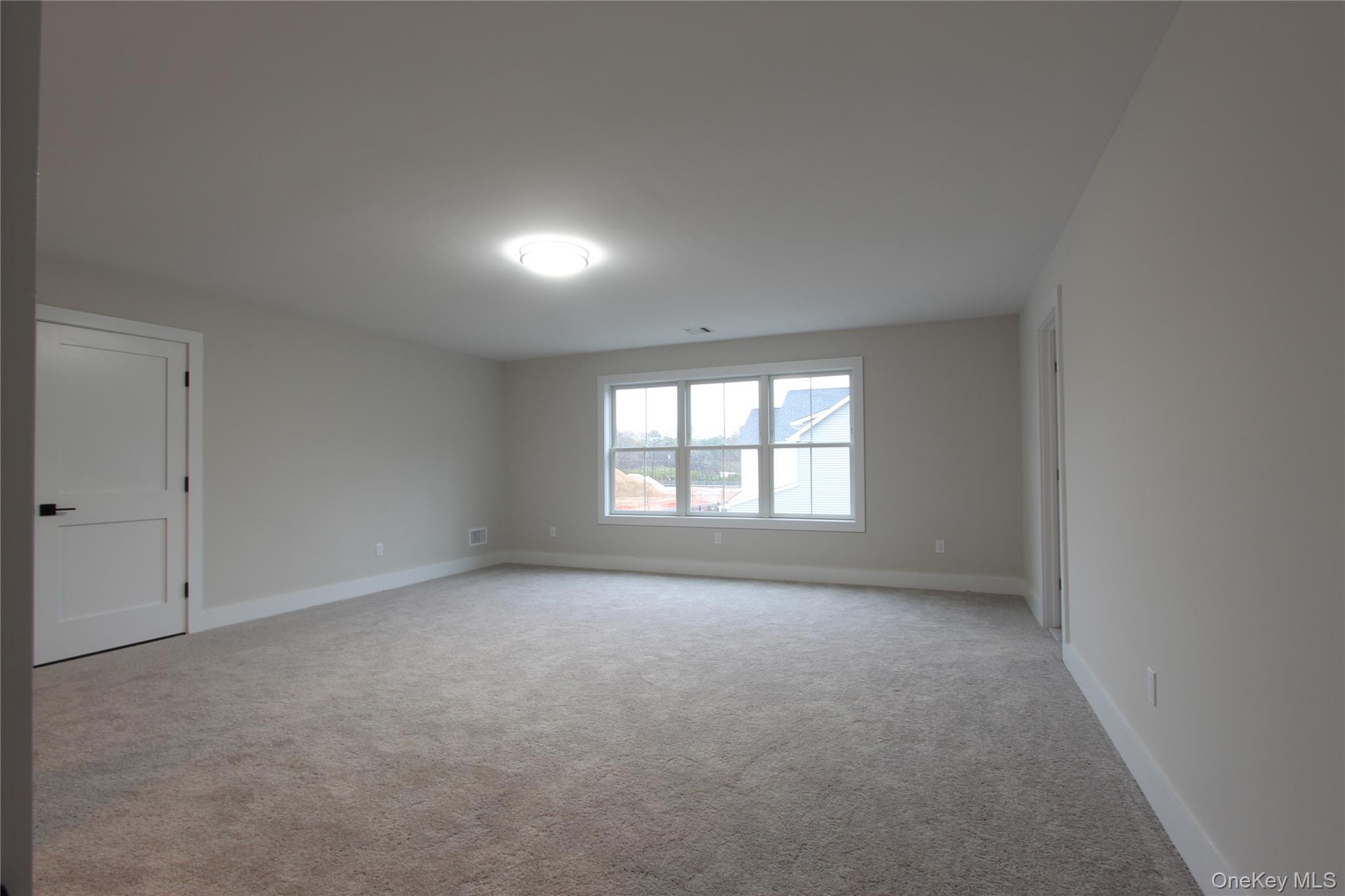 5 Colonels Path Manorville, NY 11949 - Photo 16 of 19 Unfurnished room with carpet floors and baseboards