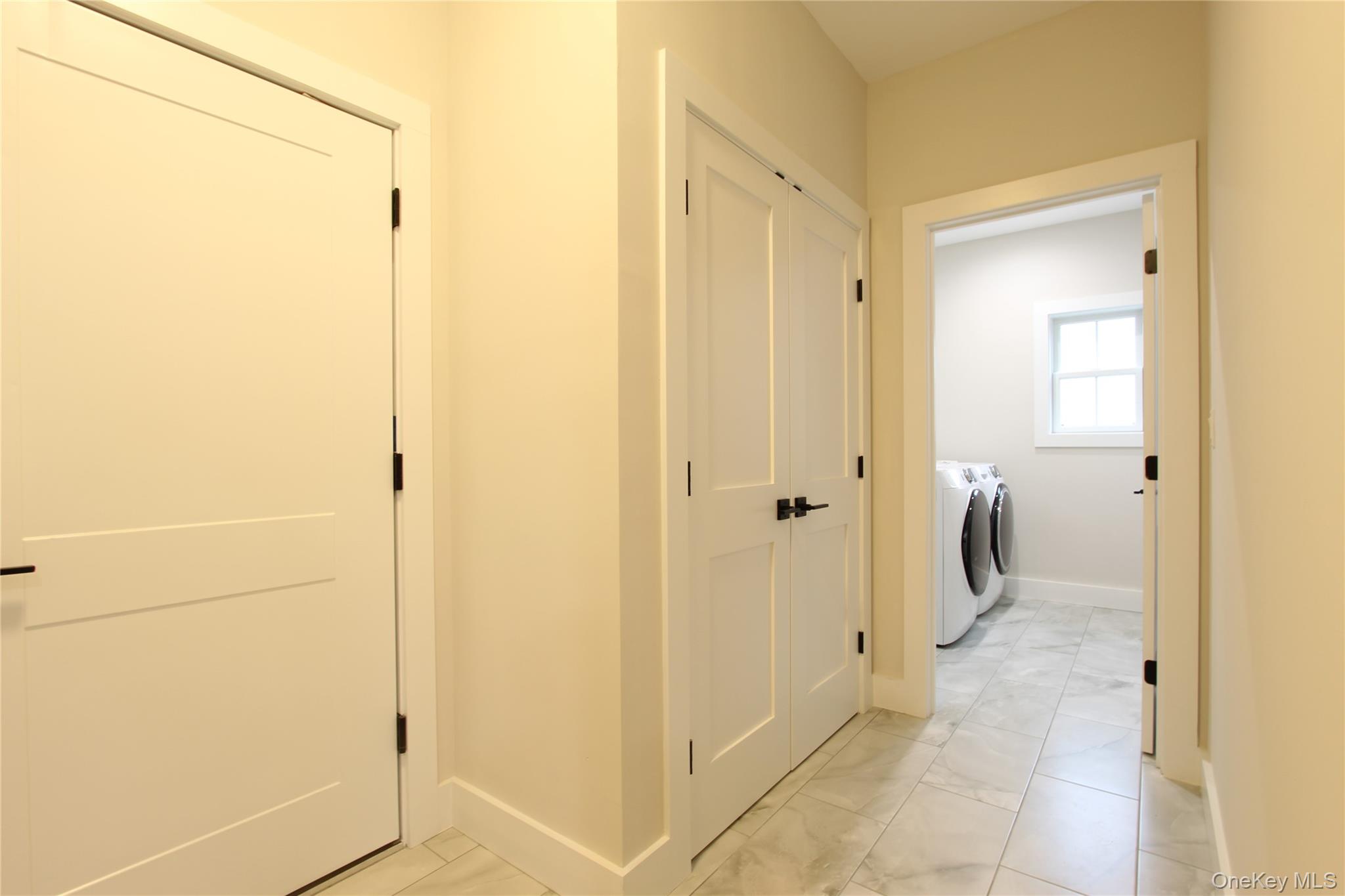 5 Colonels Path Manorville, NY 11949 - Photo 7 of 19 Washroom featuring independent washer and dryer and light marble finish floors