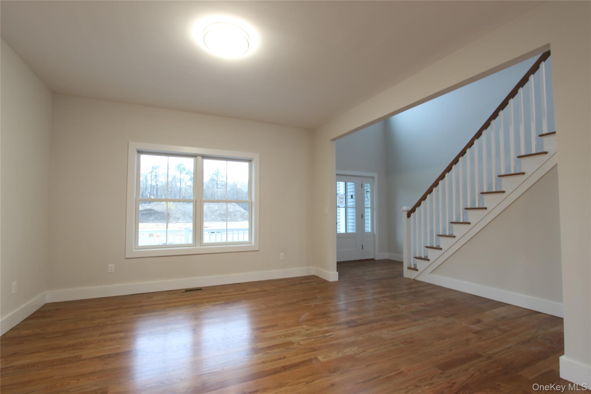 5 Colonels Path Manorville, NY 11949 - Photo 8 of 30 Large dining room featuring stairs and natural oak flooring