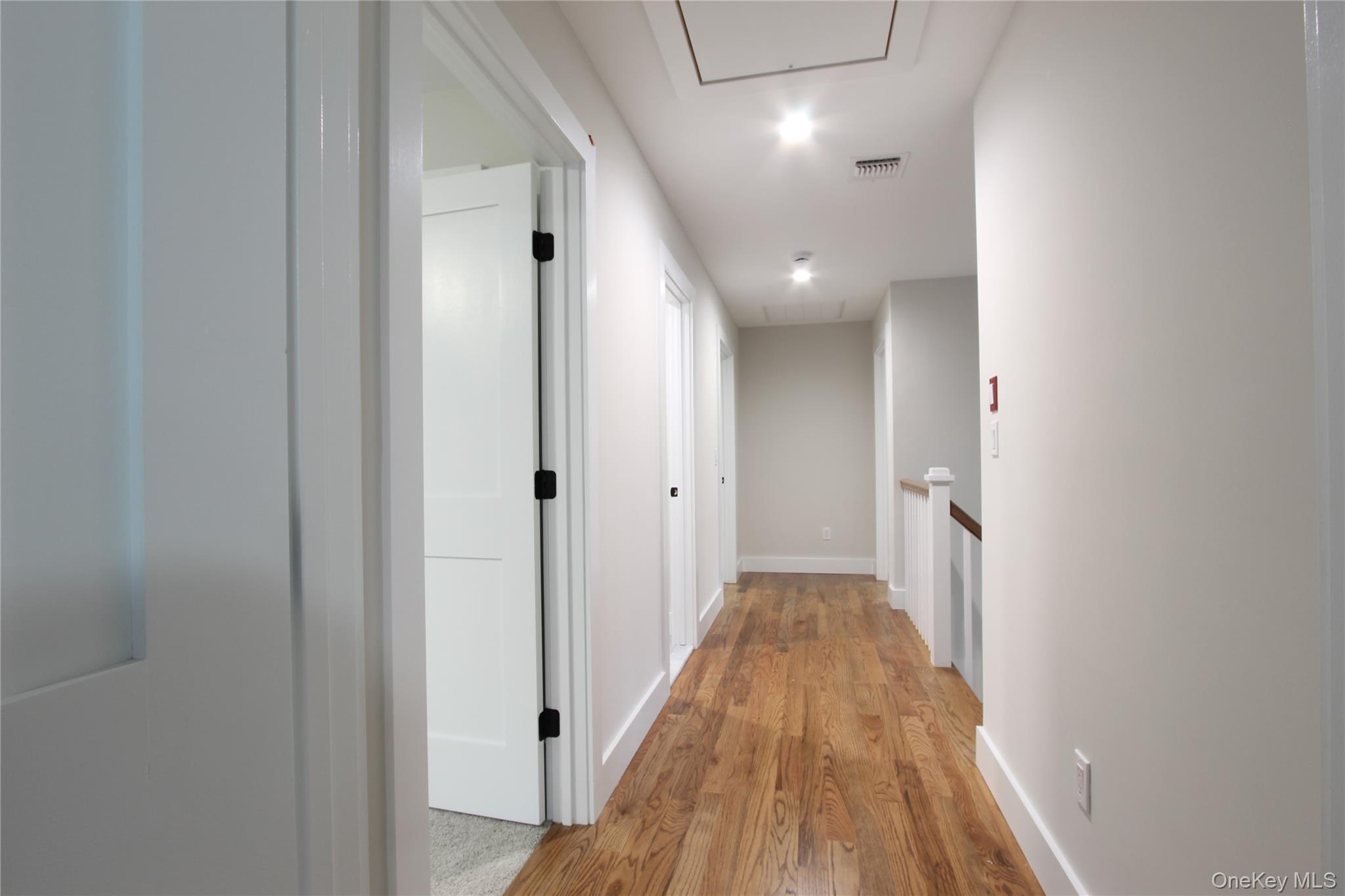 5 Colonels Path Manorville, NY 11949 - Photo 10 of 19 Hall with attic access, light wood-style floors, and an upstairs landing