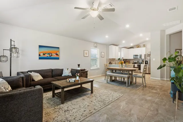 a living room with furniture and kitchen view