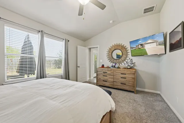 a bedroom with a bed and a dresser