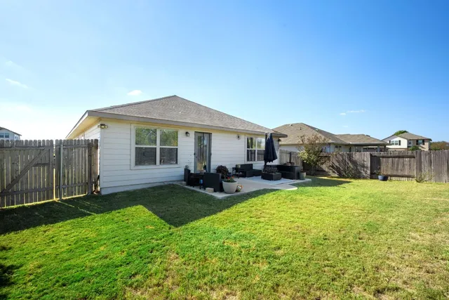 a view of a house with backyard porch and sitting area