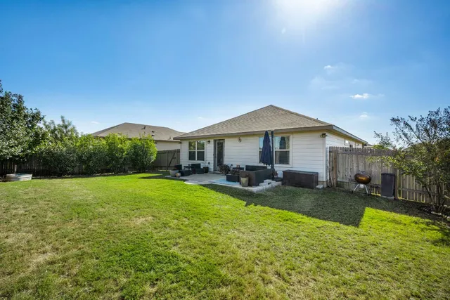a view of a house with backyard porch and garden