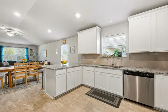 a kitchen with lots of counter top space and windows