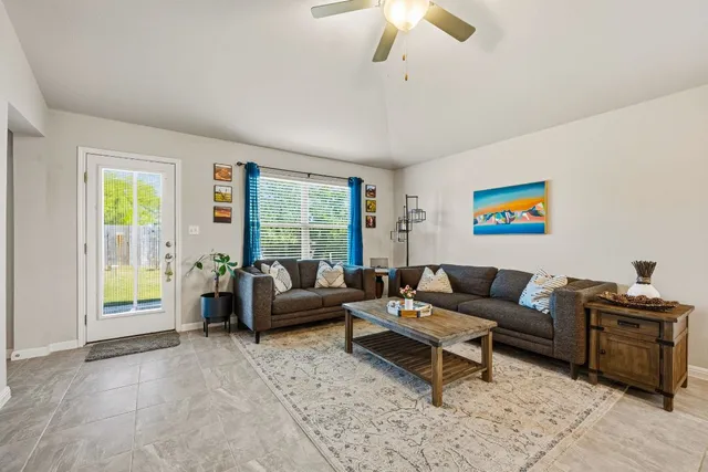 a living room with furniture and a large window