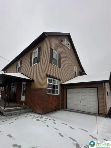 a front view of a house with garage