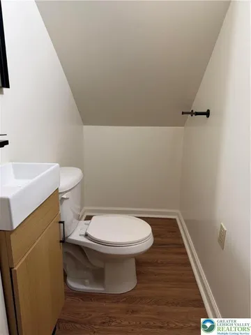a white toilet sitting next to a white sink