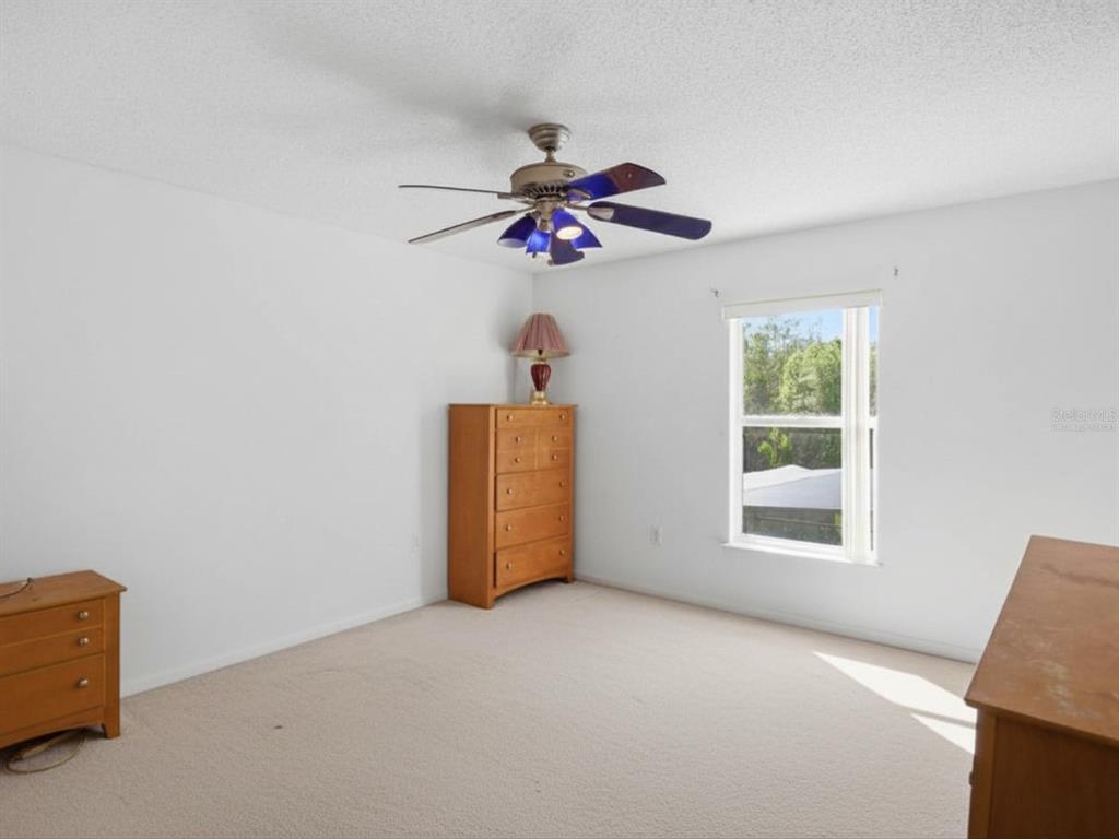 206 Taranto Way Kissimmee, FL 34758 - Photo 32 of 45 a view of a livingroom with a ceiling fan and window