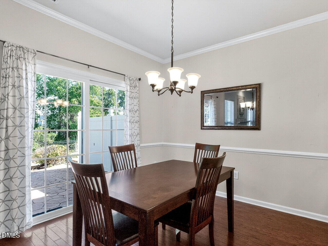 8215 Yaxley Hall Drive Raleigh, NC 27616 - Photo 12 of 42 a view of a dining room with furniture a chandelier and wooden floor