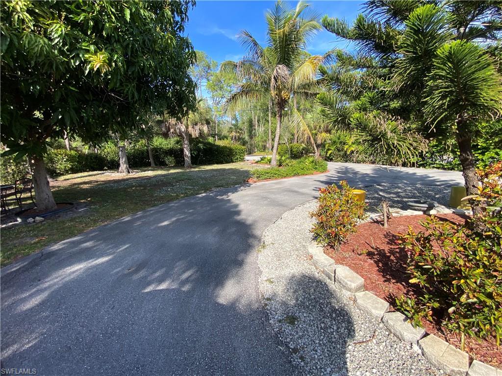 3550 23rd Avenue Southwest Naples, FL 34117 - Photo 4 of 22 a view of a street with a yard
