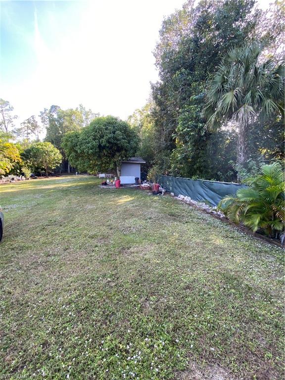 3550 23rd Avenue Southwest Naples, FL 34117 - Photo 6 of 22 a view of a field with trees in the background
