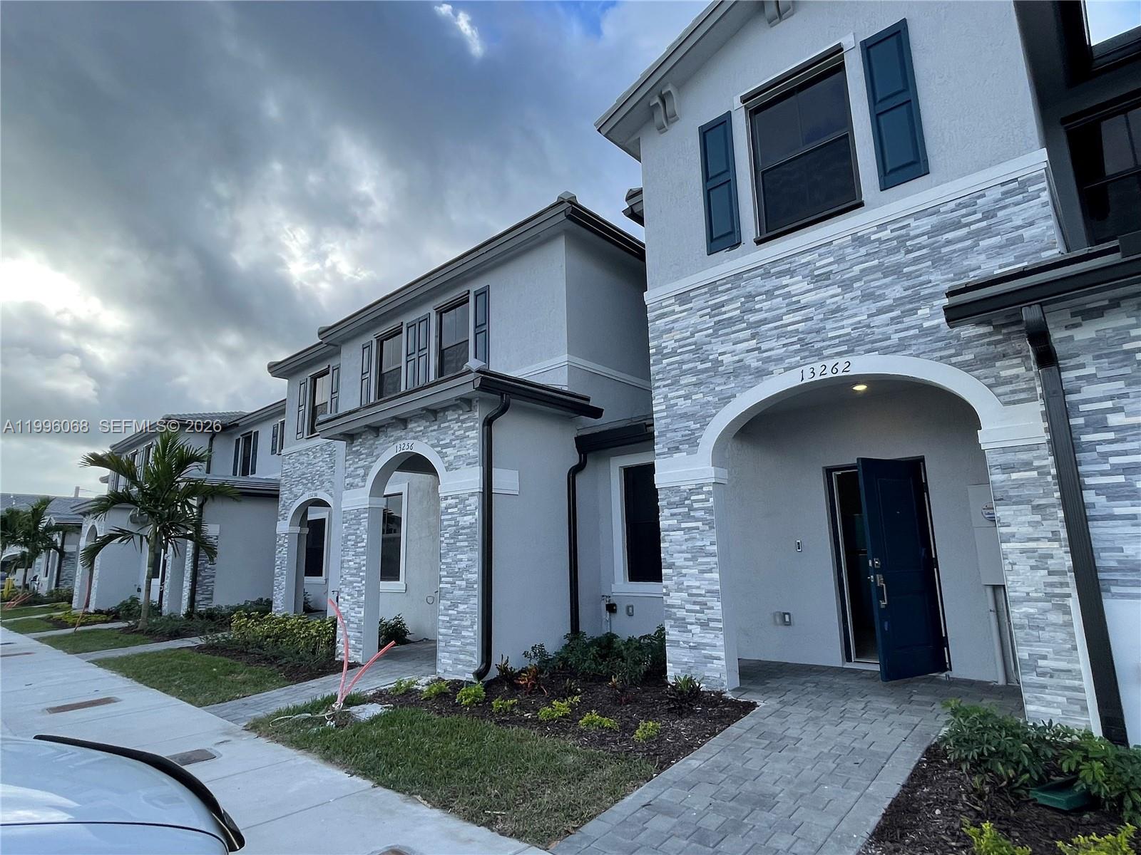 13262 Southwest 287th Terrace Homestead, FL 33033 - Photo 2 of 33 a front view of a house with a yard