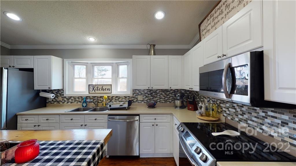 2130 Peeler Road Vale, NC 28168 - Photo 12 of 29 a kitchen with sink stove and cabinets