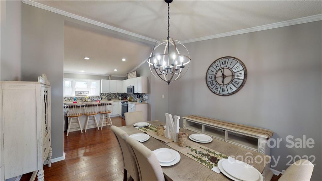 2130 Peeler Road Vale, NC 28168 - Photo 16 of 29 a very nice looking dining room with furniture a kitchen and chandelier