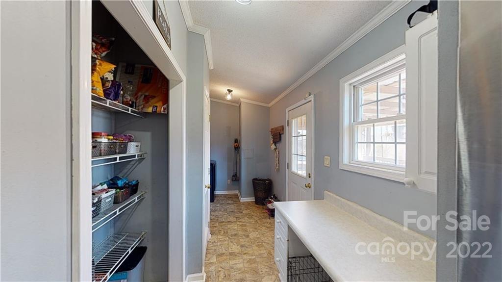 2130 Peeler Road Vale, NC 28168 - Photo 18 of 29 a view of walk in closet with clothes and a window