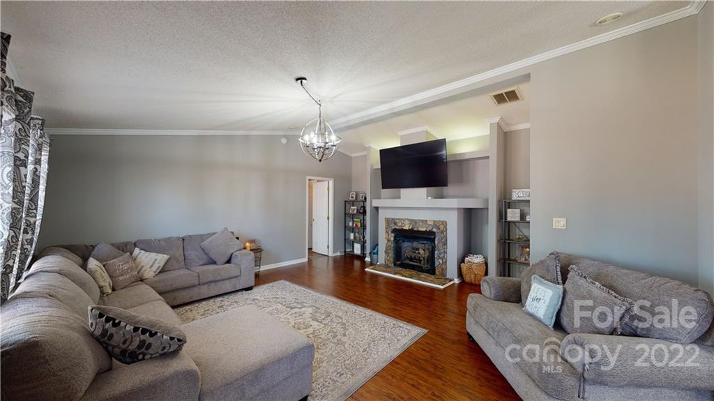 2130 Peeler Road Vale, NC 28168 - Photo 2 of 29 a living room with furniture a fireplace and a flat screen tv