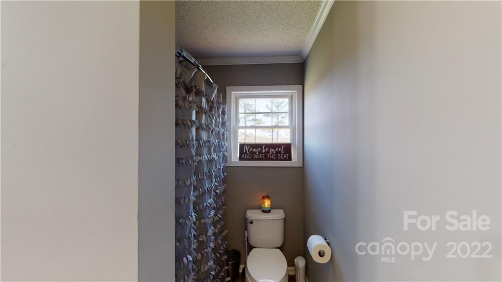 2130 Peeler Road Vale, NC 28168 - Photo 25 of 29 a bathroom with a toilet and a shower curtain