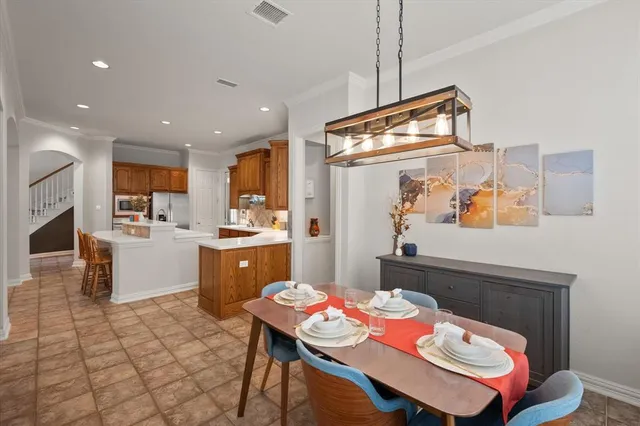 a large kitchen with stainless steel appliances lots of counter space and wooden floor