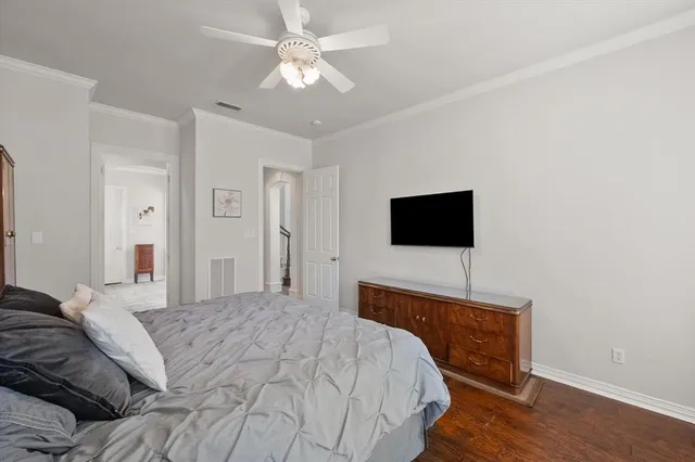 a living room with furniture a clock and a view of kitchen