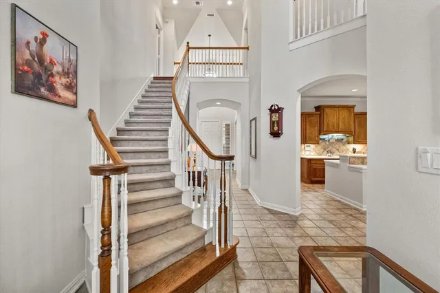 a living room with furniture a lamp and a potted plant