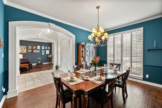a dining room with furniture window and wooden floor