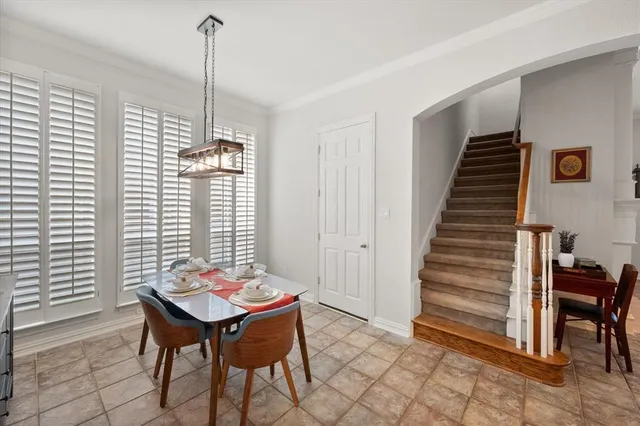 a large kitchen with stainless steel appliances a large counter top a stove and a refrigerator