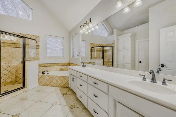 a spacious bathroom with a double vanity sink mirror and double