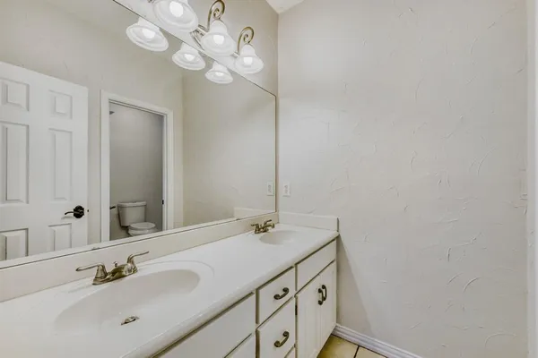 a bathroom with a sink vanity and a mirror