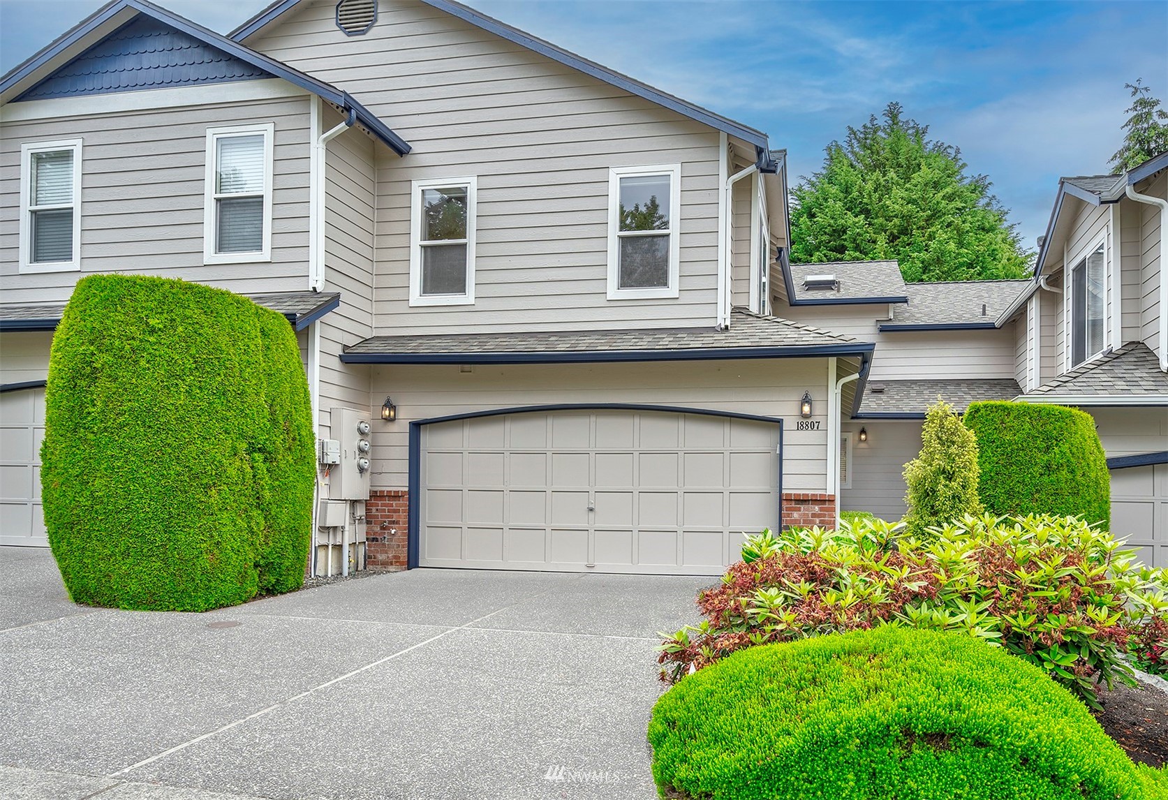 18807 19th Drive Southeast Bothell, WA 98012 - Photo 1 of 18 a front view of a house with a garden and plants