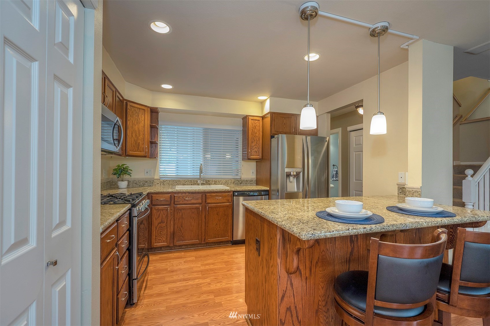 18807 19th Drive Southeast Bothell, WA 98012 - Photo 5 of 18 a kitchen with stainless steel appliances granite countertop a sink stove and refrigerator