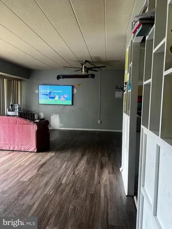 a view of a room with wooden floor