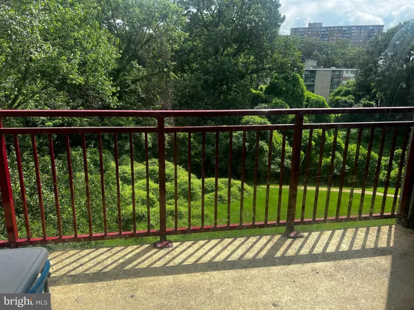 a view of a balcony with a floor to ceiling window and wooden floor