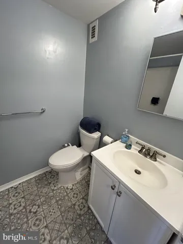 a bathroom with a sink a toilet and mirror