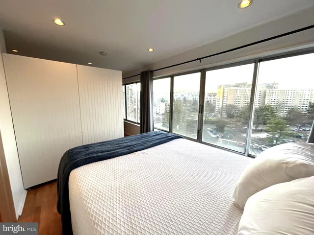 a bedroom with a large bed and a large window