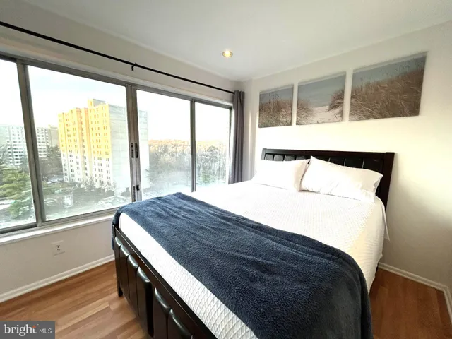 a bedroom with a large bed and a large window