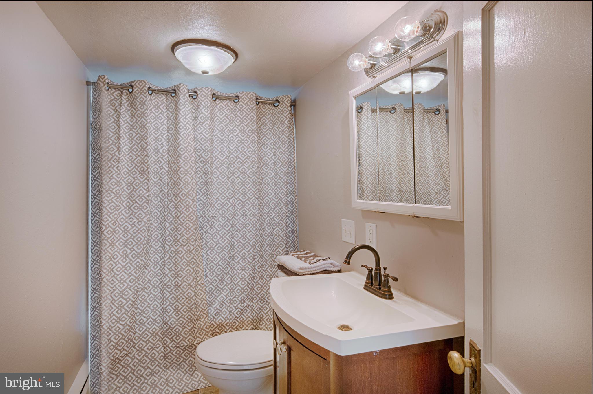 2415 Rocks Road Forest Hill, MD 21050 - Photo 16 of 30 a bathroom with a sink a toilet and shower